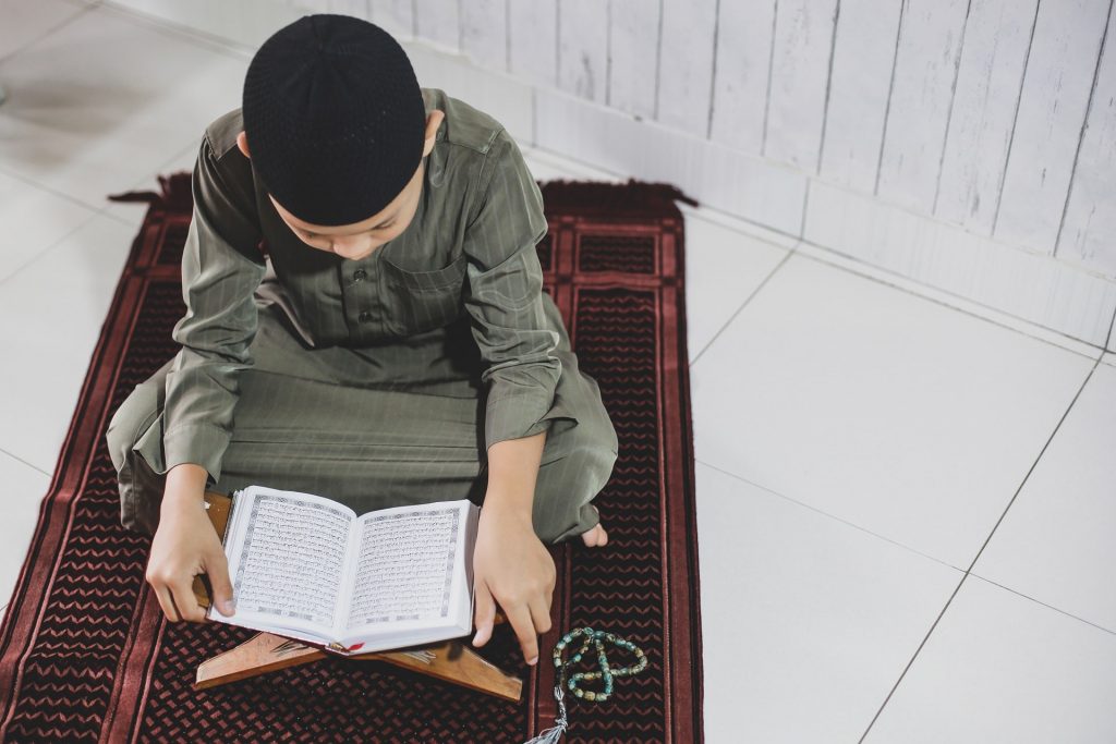 muslim-boy-reading-holy-quran-2021-08-30-06-01-29-utc-min-1024x683